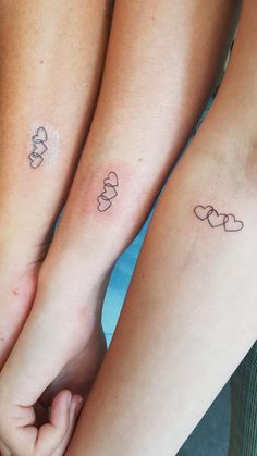 two people holding hands with tattoos on their arms and feet, both have mickey mouses on them