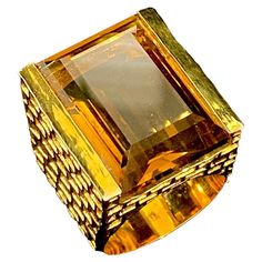 The large Emerald Cut Whiskey Quartz set within a deeply chiselled 'Brutalist' mount; this is a fabulously striking ring entering on a beautifully cut, bright & well proportioned stone. The stone measures 22mm x 15mm; the ring stands 11mm 'proud' on the finger. This ring is a US size 8. While it can not be re-sized, it is available to order in other sizes. Luxury Diamond Cut Collectible Rings, Luxury Collectible Diamond Cut Rings, Luxury Faceted Rings For Formal Occasions, Luxury Modern Emerald-cut Ruby Ring, Luxury Faceted Topaz Ring, Unique Luxury Cabochon Emerald Ring, Luxury Yellow Gold Emerald-cut Crystal Ring, Green Emerald-cut Crystal Ring With Center Stone, Luxury Collectible Brutalist Jewelry