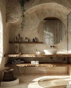 a bathroom with stone walls and flooring is pictured in this image, there are two sinks on either side of the counter