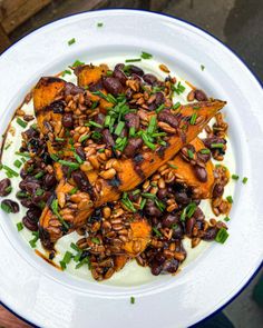 a white plate topped with beans and other food