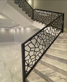 a marble staircase with metal handrails in an empty building