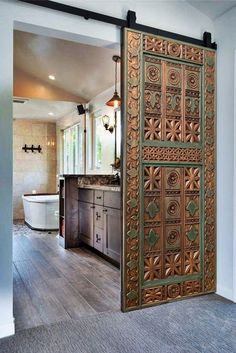 an open door leading to a bathroom with wood floors