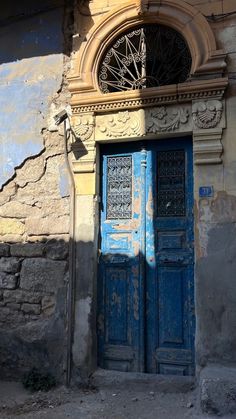 an old building with a blue door and window