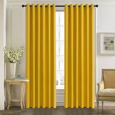 the yellow curtains in this room are ready to be hung