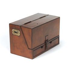 a brown leather box with two compartments on the front and one drawer open to show what is inside