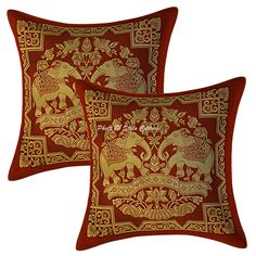 two red and gold pillows with elephants on them