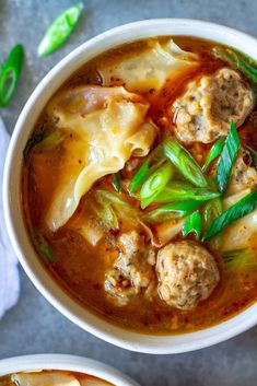 two bowls filled with meat and vegetable soup