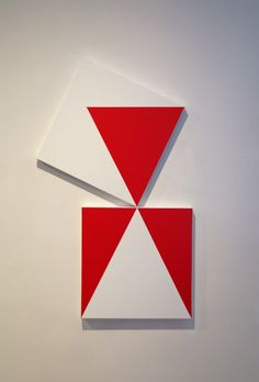 two red and white squares are on the wall