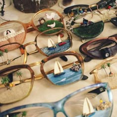 many different types of glasses with small sailboats on them