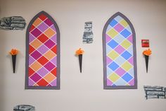 the wall is decorated with paper flowers and stained glass windows