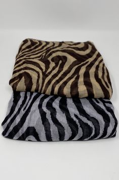 two zebra print blankets sitting on top of each other