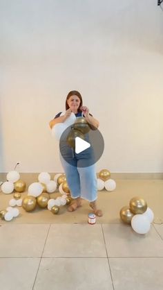 a woman is standing in front of balloons