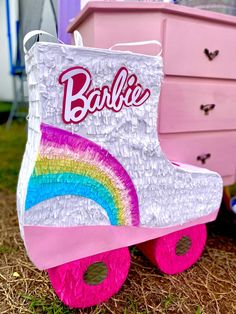 a pair of pink roller skates with barbie's name on the front and side