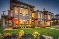 a large house with lots of windows and landscaping