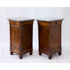 pair of wooden nightstands with marble top