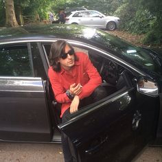 a man sitting in the driver's seat of a car