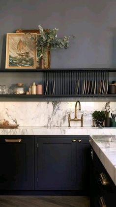 a kitchen with marble counter tops and black cabinets, along with open shelving above the sink