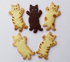 four cookies shaped like cats sitting on top of each other