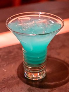 a blue drink sitting on top of a table