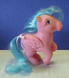 a pink toy horse with blue hair and wings