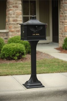 a mailbox on the sidewalk in front of a house