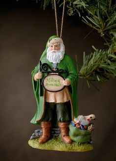 a christmas ornament with a gnome holding a pie and a dog on it