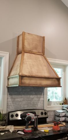 a stove top oven sitting inside of a kitchen next to a wall mounted heater