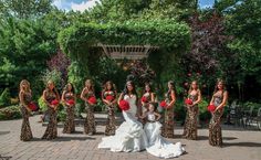 the bride and her bridal party pose for a photo in their leopard print dresses