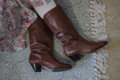 Vintage 80s leather low heel slouchy cowboy boots with beautiful side leather abstract detailing. Perfect with jeans or summer skirts and dresses. Or pair them with elegant trousers and blazer. Marked size 37, they fit modern 36,5 Eu Outside leather, wooden heel, lined with checkered cotton textile. Trade mark Deichmann City Very good vintage condition, used couple of times, have some minor signs of years, overall excellent in quality and look. Summer Mid-calf Boots, Brown Knee-length Boots For Spring, Brown Knee-length Spring Boots, Vintage Wide Calf Mid-calf Boots For Fall, Vintage Leather Mid-calf Boots, Vintage Wide Calf Mid-calf Boots For Winter, Wide Calf Vintage Mid-calf Boots, Vintage Pointed Toe Mid-calf Boots For Fall, Vintage Winter Mid-calf Boots With Pointed Toe