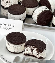 oreo cookies and ice cream sandwiches on a white plate with a sign that says handmade