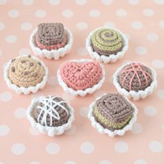 six crocheted heart shaped pastries sitting on a polka dot tablecloth