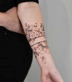 a woman's arm with flowers on it