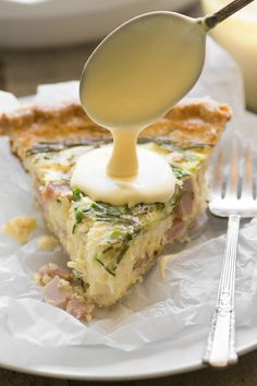 a piece of quiche is being drizzled with butter on the fork