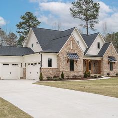 a brick and stone house with two garages