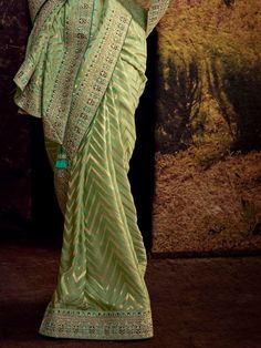 Create your occasional look more impressive by enrobing yourself in this stunning green Banglory silk party wear saree with a blouse. Crafted with precision and elegance, this saree is truly a masterpiece that will make you stand out at any event or party.
Firstly, it is made of high-quality Banglory silk fabric, ensuring a comfortable and luxurious feel against your skin. The stunning green color adds a touch of vibrancy and freshness to your overall look, making you the center of attention whe Green Semi-stitched Pre-draped Saree With Meenakari, Green Pre-draped Saree For Eid Party, Elegant Fitted Meenakari Saree, Green Raw Silk Pre-draped Saree With Self Design, Festive Green Pre-draped Saree With Pallu, Festive Pista Green Banarasi Silk Pre-draped Saree, Festive Green Pre-draped Saree With Self Design, Green Pre-draped Saree With Zari Weaving For Diwali, Festive Green Silk Pre-draped Saree