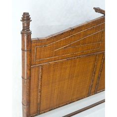 an old bamboo bed frame with wooden posts and slats on the headboard, against a white background