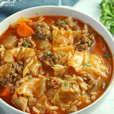 a white bowl filled with cabbage and meat soup