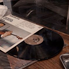 a black and white photo of an old vinyl record with the cover pulled out on a table