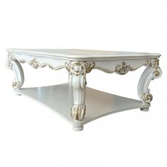 a white coffee table with an ornate design on it's top and bottom shelf