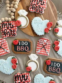 decorated cookies are arranged on a wooden platter with the words i do bbq