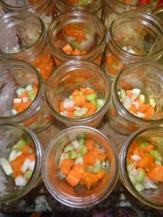 many jars filled with different types of vegetables