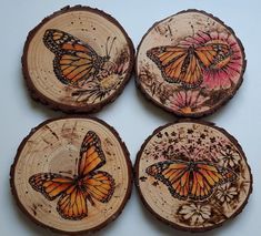 four pieces of wood with butterflies painted on them