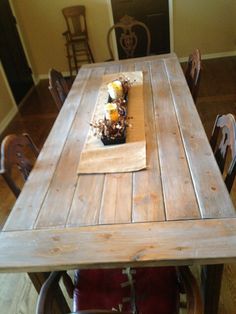 a wooden table with chairs around it