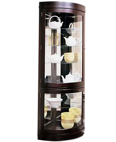 a corner display case with tea cups and saucers