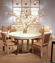 a round table with chairs around it in a room