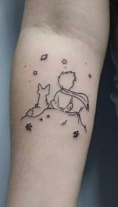 a small tattoo on the arm of a woman with two foxes and stars in the sky