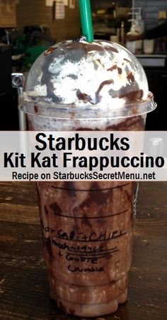 starbucks coffee drink with whipped cream and chocolate toppings in a plastic cup on top of a wooden table