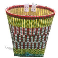 a colorful basket with two dices in it and some writing on the top of it