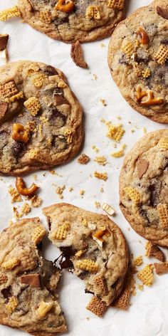 four cookies with peanut butter and chocolate chips on top, one is broken in half