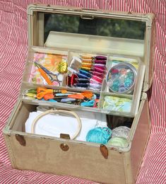 an open suitcase filled with crafting supplies